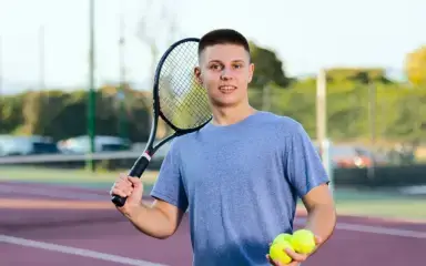 Student playing tennis