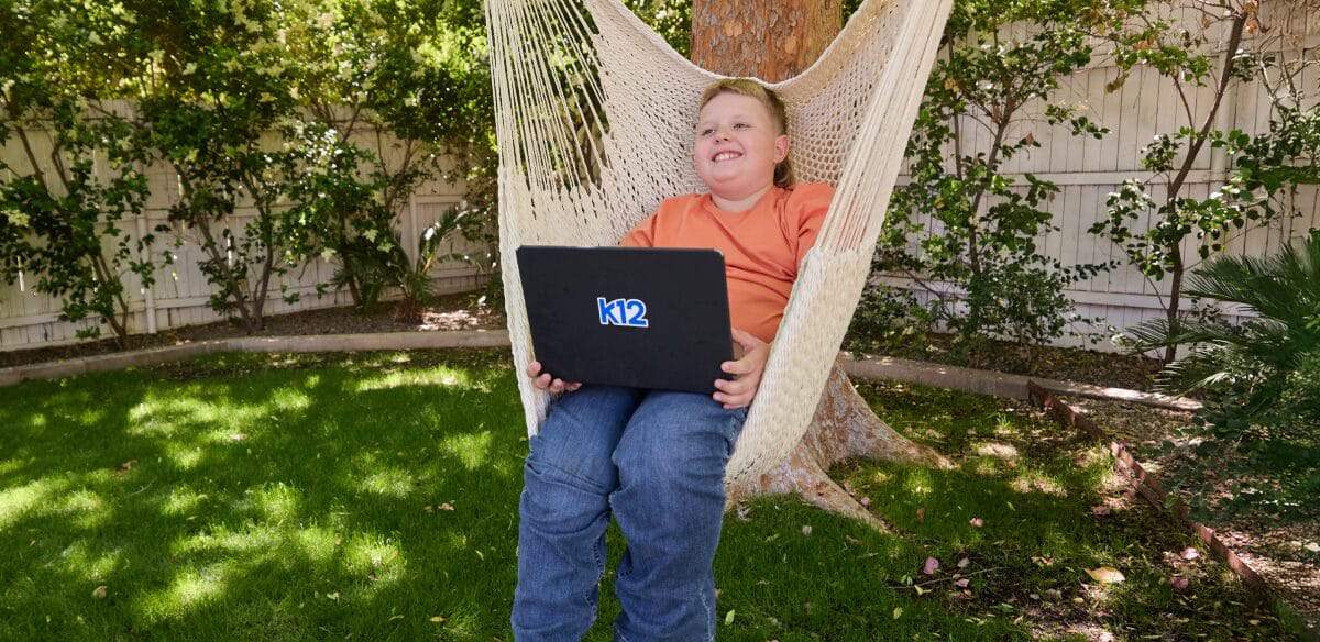 boy with computer at the park