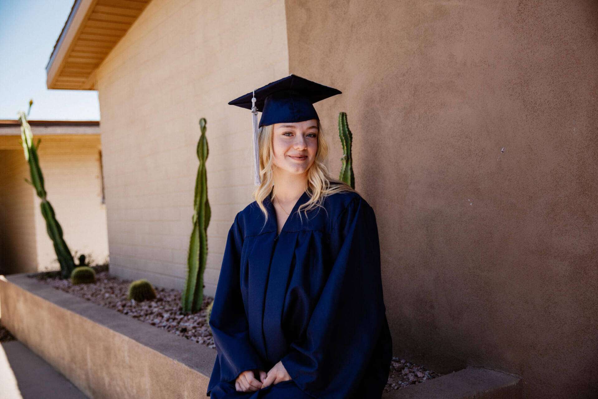 Brianna, a 16-year-old graduate of Arizona Virtual Academy, smiles in her cap and gown.