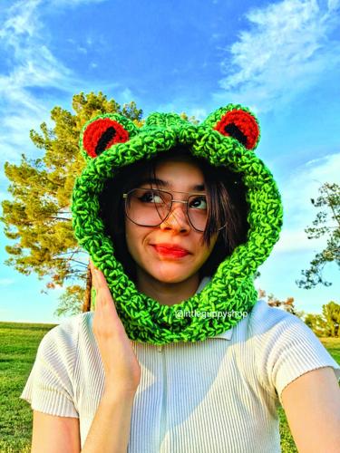 Mesa teen Linda Hernandez models a crocheted hat she made.