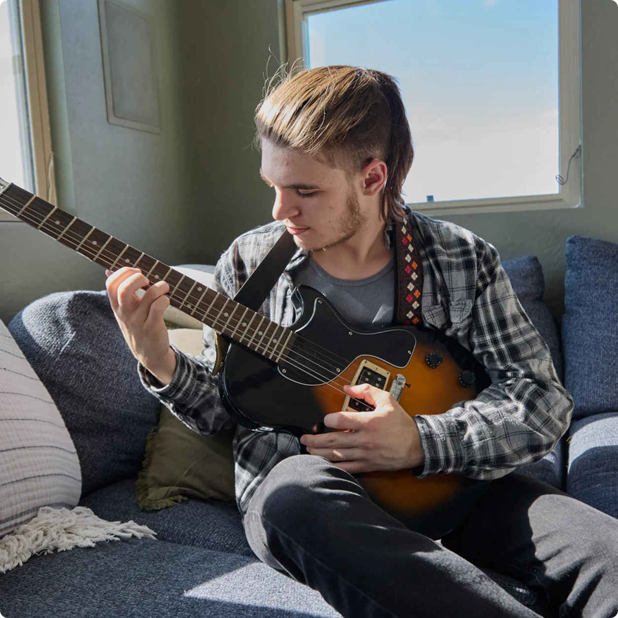 Student playing the guitar